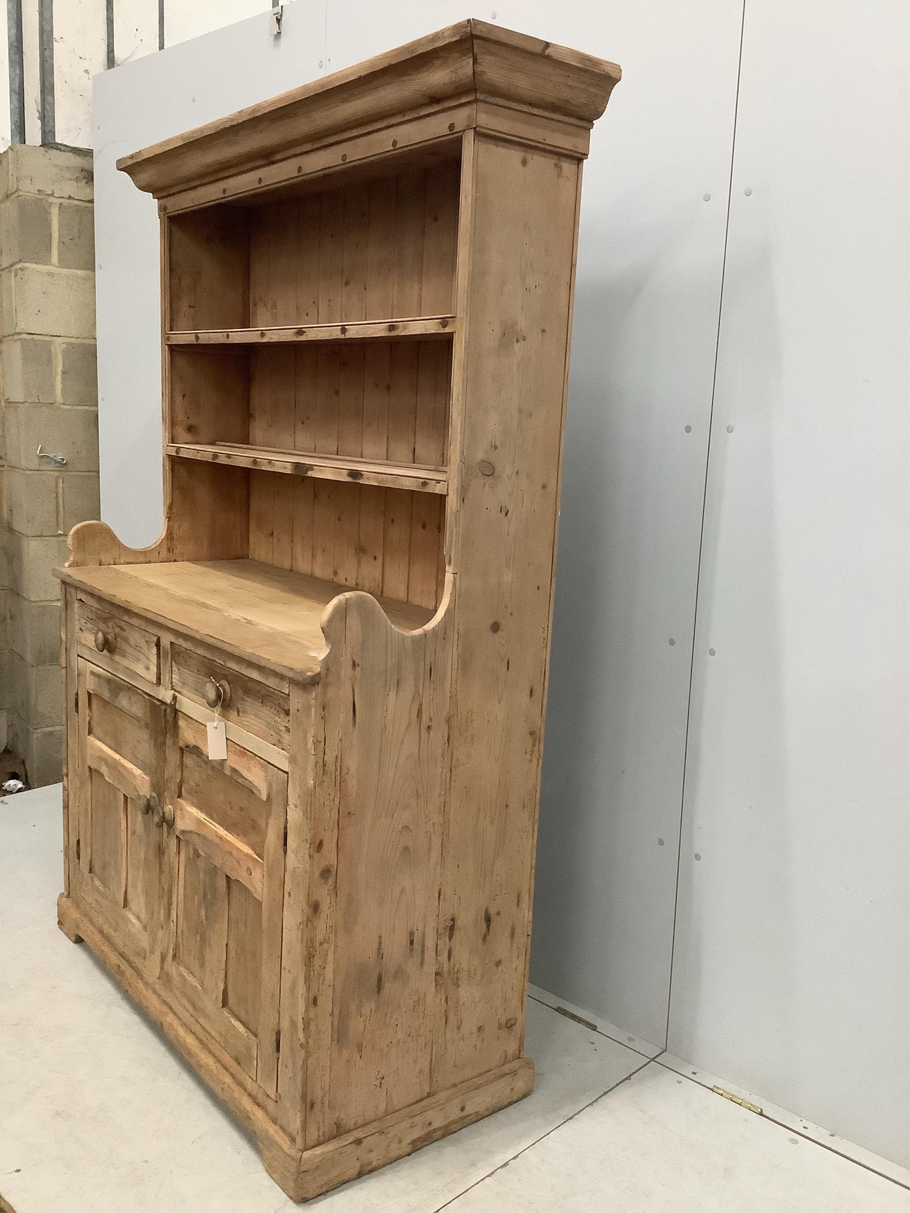 A 19th century Irish pine dresser with boarded rack, width 124cm, 51cm, height 122cm. Condition - fair